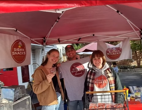 Sigma Snacks Pittsburgh vendor team sampling their energy cookies at a YinzMart pop-up event