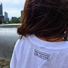 White shirt with a goose graphic that says three rivers silly goose patrol - back of shirt with neighborhood collective logo