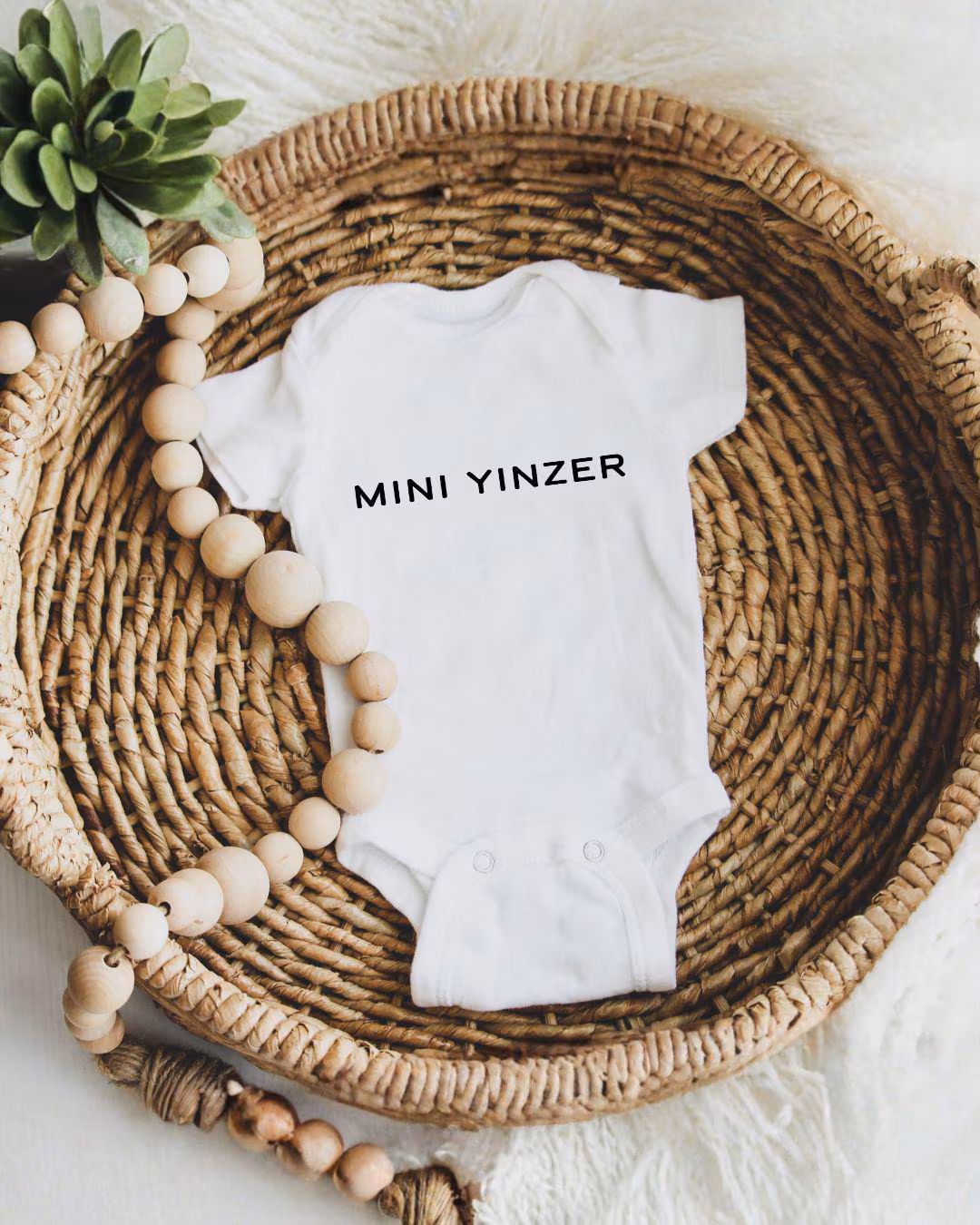 Mini Yinzer Pittsburgh Baby Onesie - Shop Local Pittsburgh - neighborhoodcollective.pgh Mini Yinzer Pittsburgh Baby Onesie, White onesie with black text that says MINI YINZER
